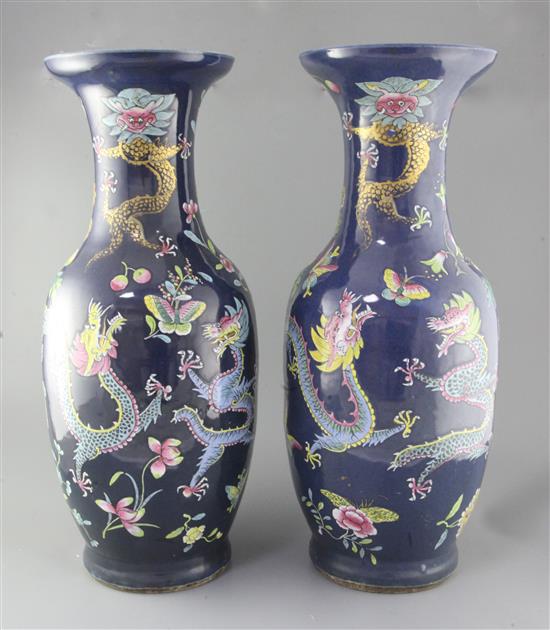 A pair of large Chinese blue ground dragon and phoenix vases, 19th century, restorations